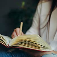 Woman Writing in Journal